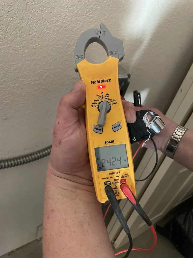 Voltage testing with clamp meter during Electrical Installation Services in Tiffin